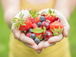 mixed berries being held by a woman who is trying to conceive