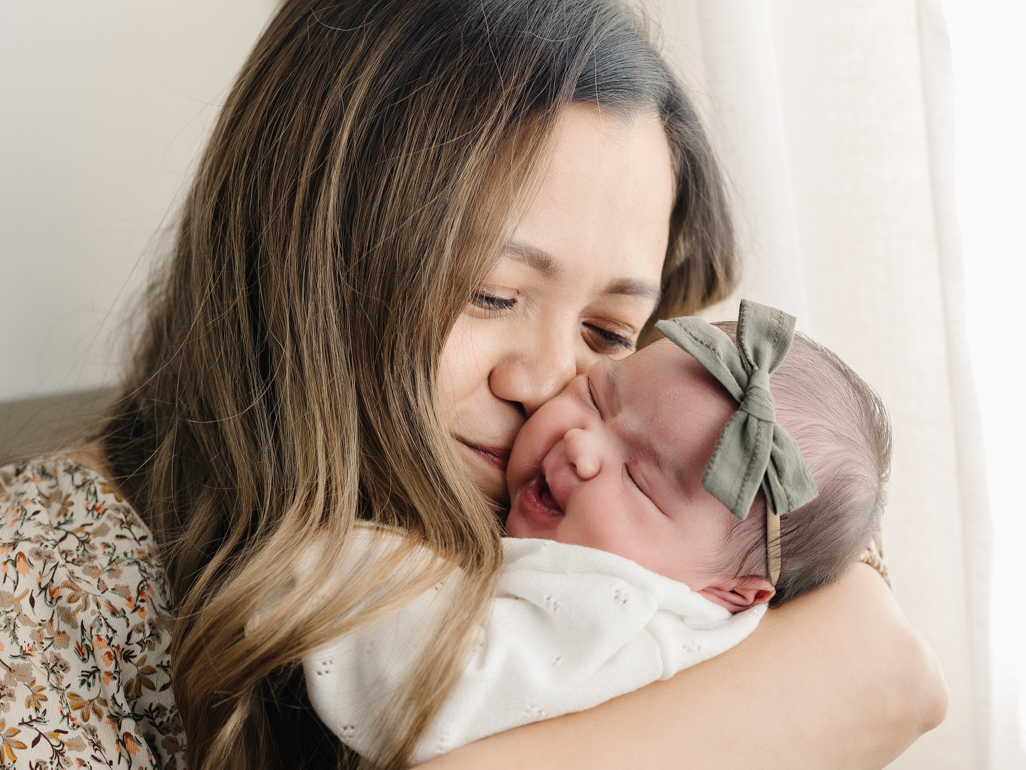 Mum cuddling her newborn baby