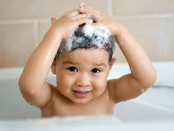 Little boy in bath washing his hair