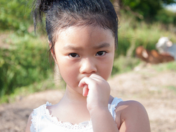 Little girl biting nails