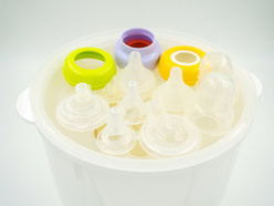 baby bottles and teats in a steriliser