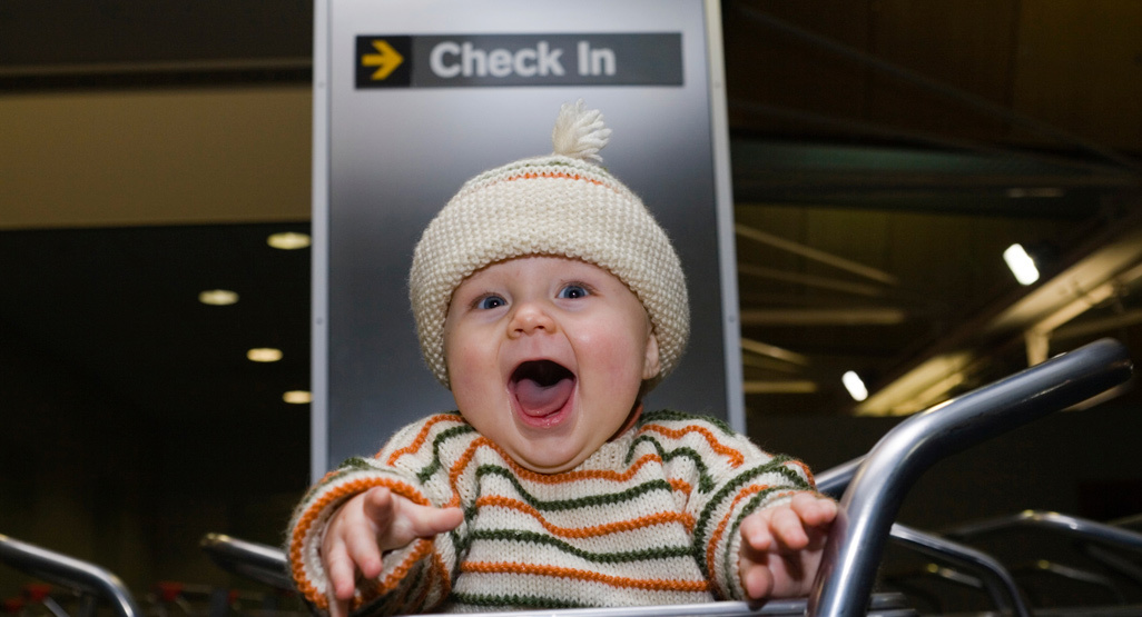 Laughing baby at an airport check-in