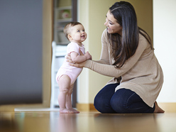 Mum helping baby to walk